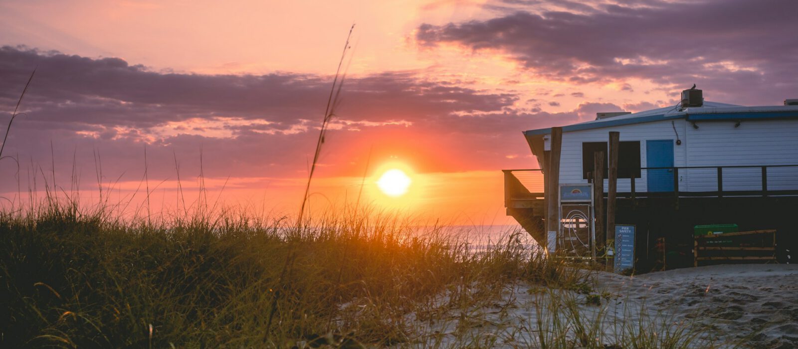 Ocean sunset next to a small house